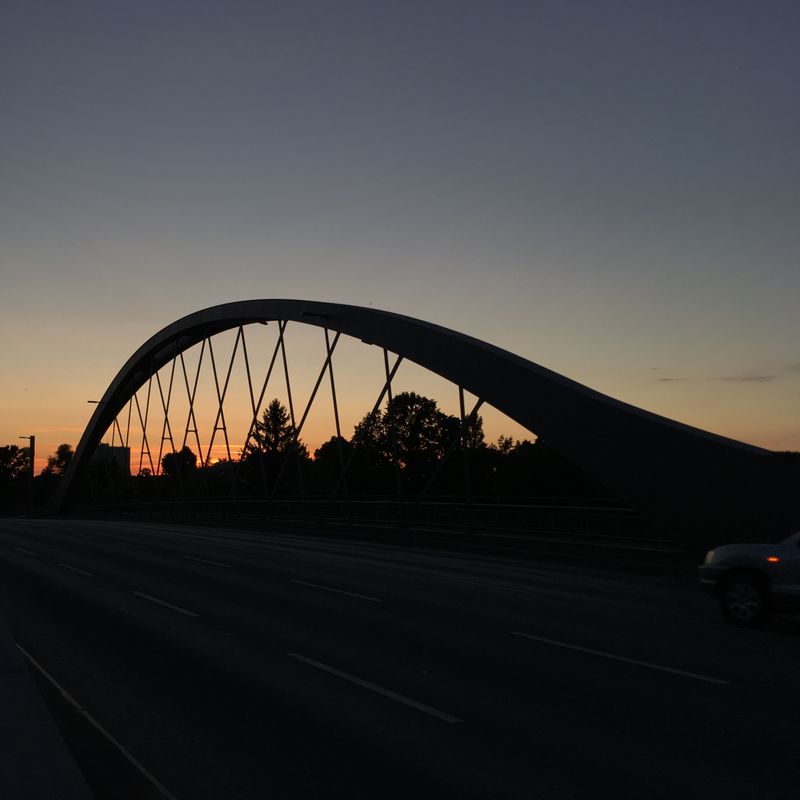 a bridge in front of the sunset