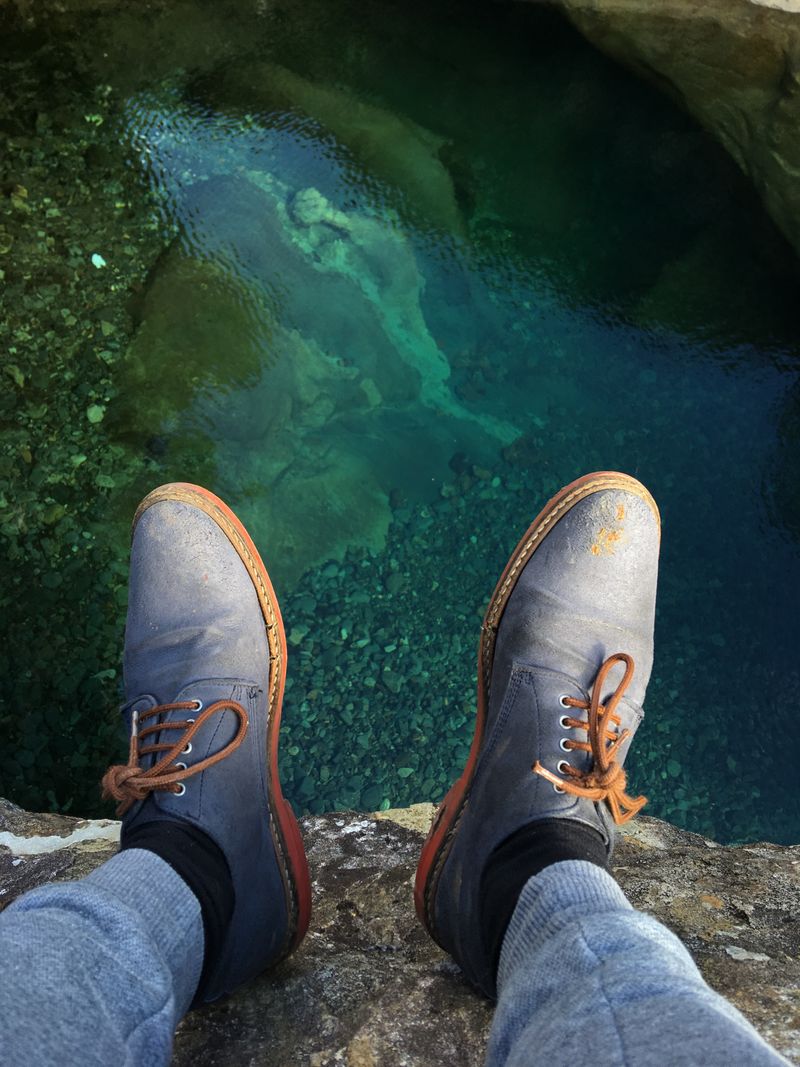 shoes with a natural pool in the background