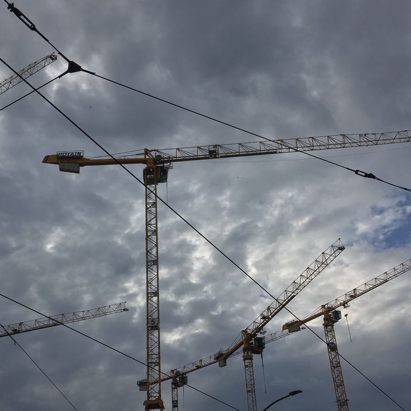 cranes in front of a cloudy sky