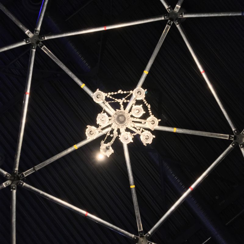chandelier hanging from a metal dome